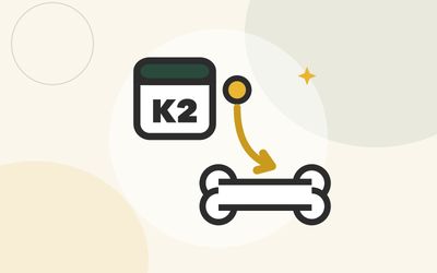Illustration of a tile reading K2 with an arrow guiding a gold dot into a bone